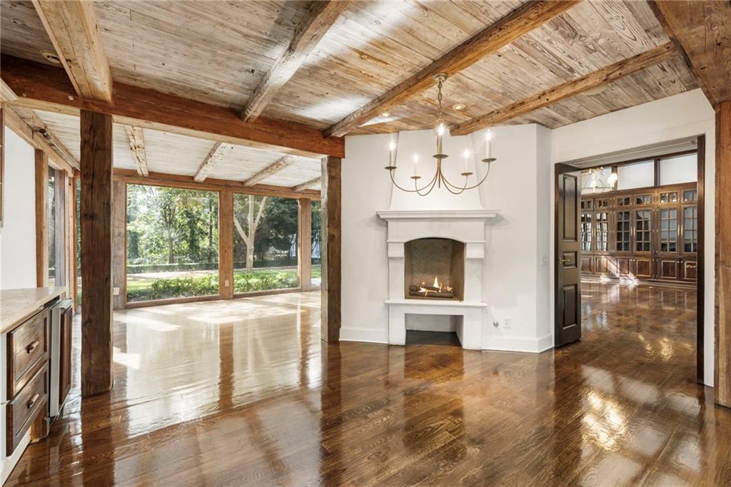 2485 West Wesley Road Northwest Atlanta, GA 30327 - Photo 23 of 84 a view of an empty room with a fireplace and a window