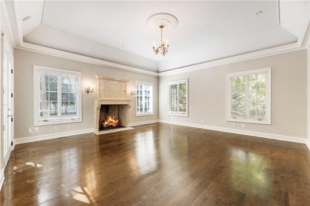 2485 West Wesley Road Northwest Atlanta, GA 30327 - Photo 34 of 84 a view of an empty room with wooden floor fireplace and a window