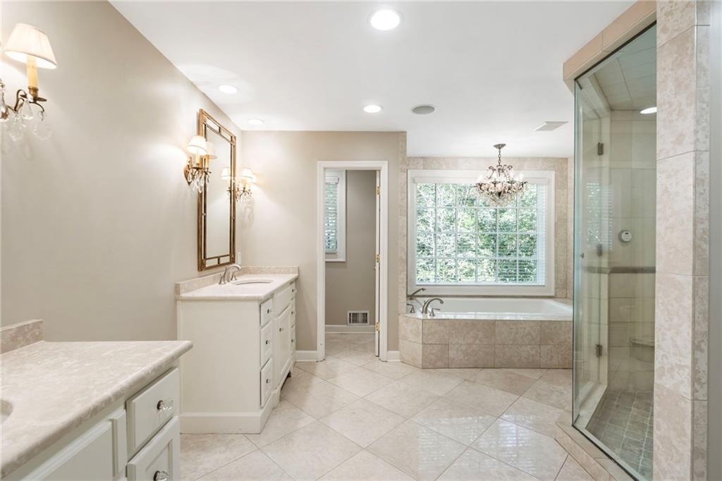 2485 West Wesley Road Northwest Atlanta, GA 30327 - Photo 36 of 84 a bathroom with a granite countertop sink a toilet and shower
