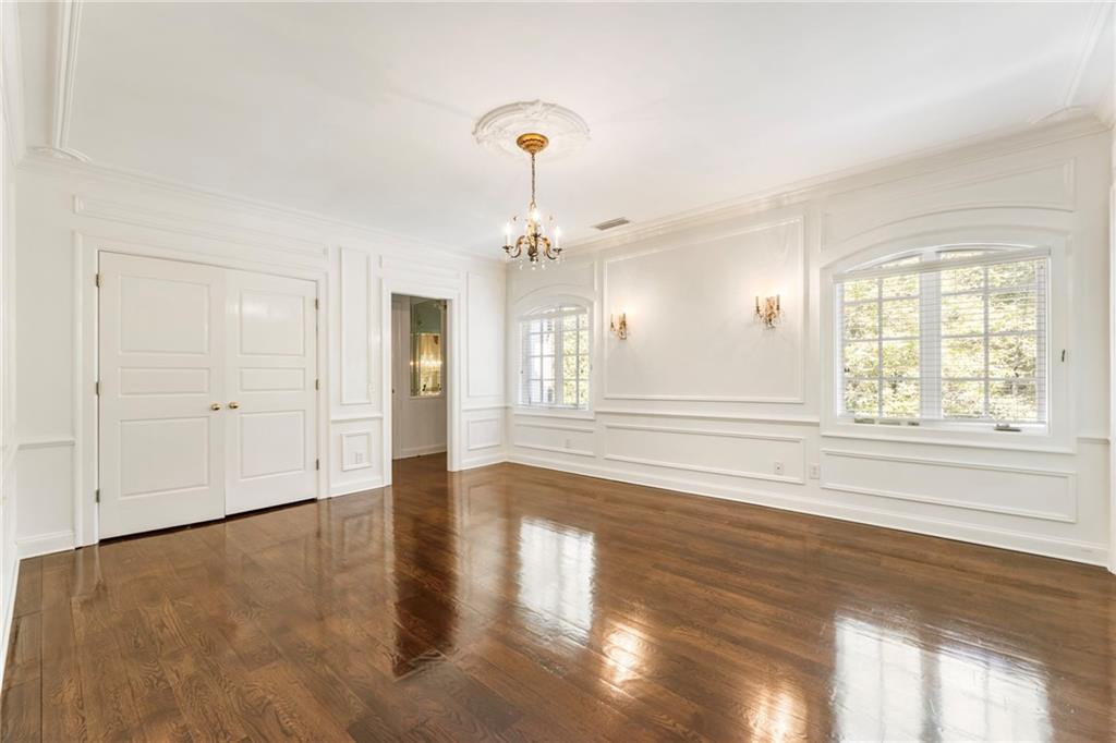 2485 West Wesley Road Northwest Atlanta, GA 30327 - Photo 49 of 84 wooden floor in an empty room with a window