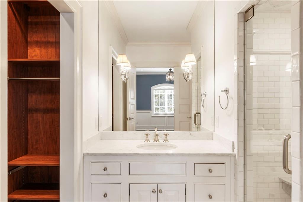 2485 West Wesley Road Northwest Atlanta, GA 30327 - Photo 53 of 84 a bathroom with a granite countertop sink vanity mirror and shower