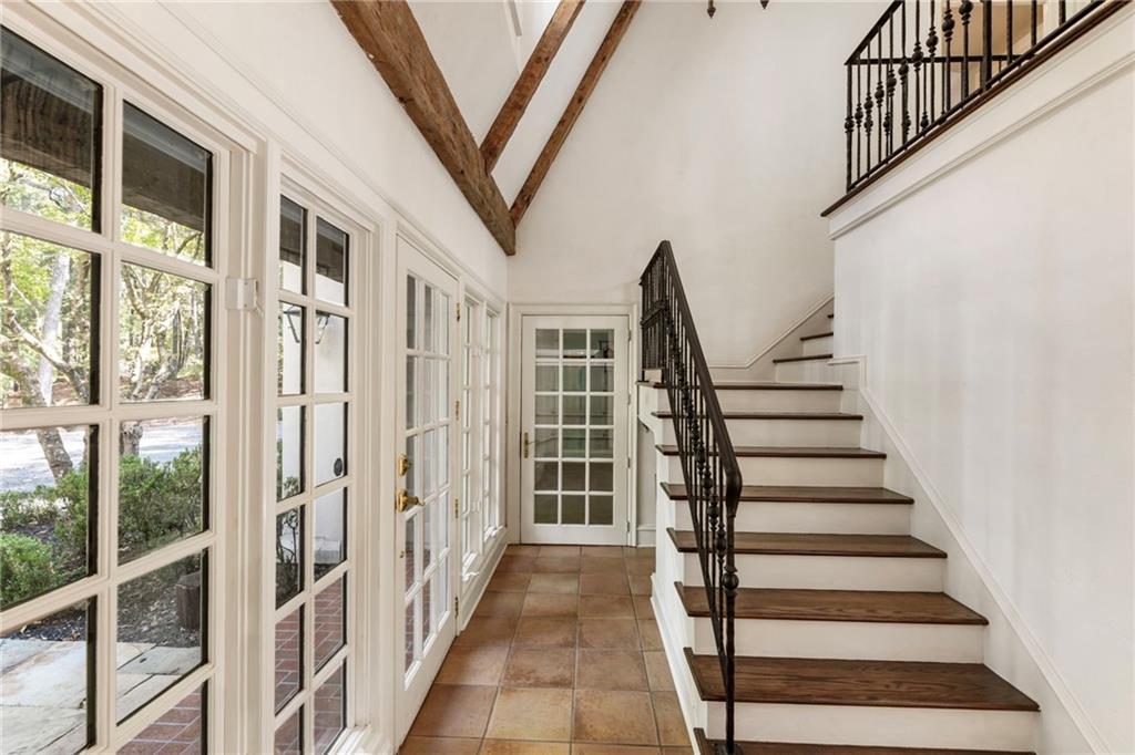 2485 West Wesley Road Northwest Atlanta, GA 30327 - Photo 59 of 84 a view of staircase with lots of frames on wall and a large window