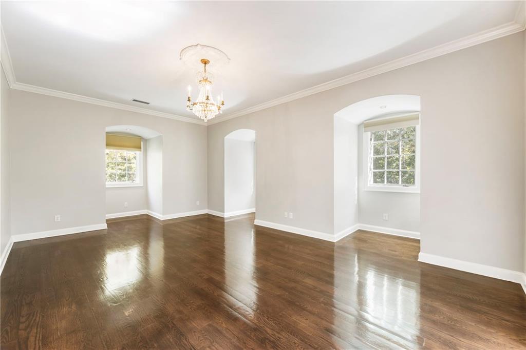 2485 West Wesley Road Northwest Atlanta, GA 30327 - Photo 60 of 84 a view of an empty room with wooden floor and a window