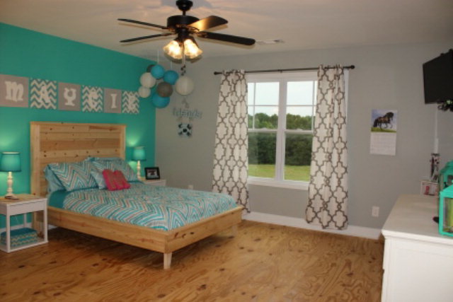 700 King Road Forsyth, GA 31029 - Photo 17 of 22 a bedroom with a bed and a chandelier