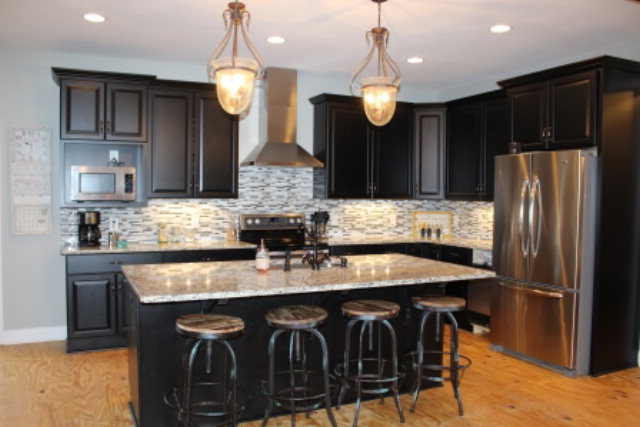 700 King Road Forsyth, GA 31029 - Photo 8 of 22 a kitchen with granite countertop a table chairs stainless steel appliances and cabinets