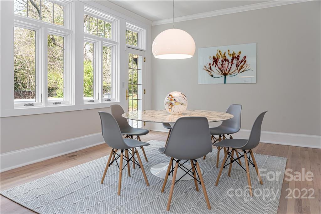343 Vanderbilt Road Asheville, NC 28803 - Photo 18 of 48 a view of a dining room with furniture a rug and wooden floor