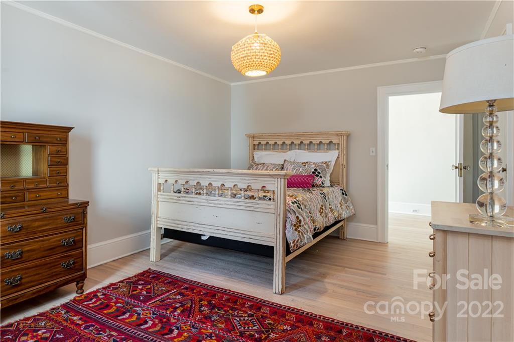 343 Vanderbilt Road Asheville, NC 28803 - Photo 33 of 48 a bedroom with a bed and a lamp on table
