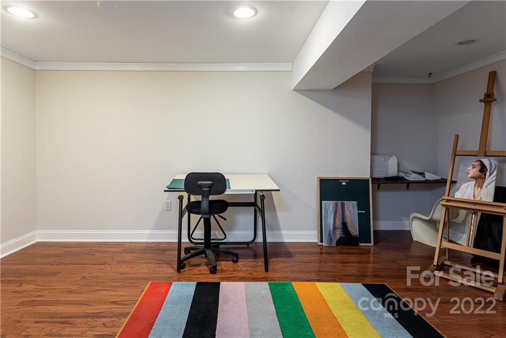 343 Vanderbilt Road Asheville, NC 28803 - Photo 38 of 48 a view of a workspace with furniture and wooden floor