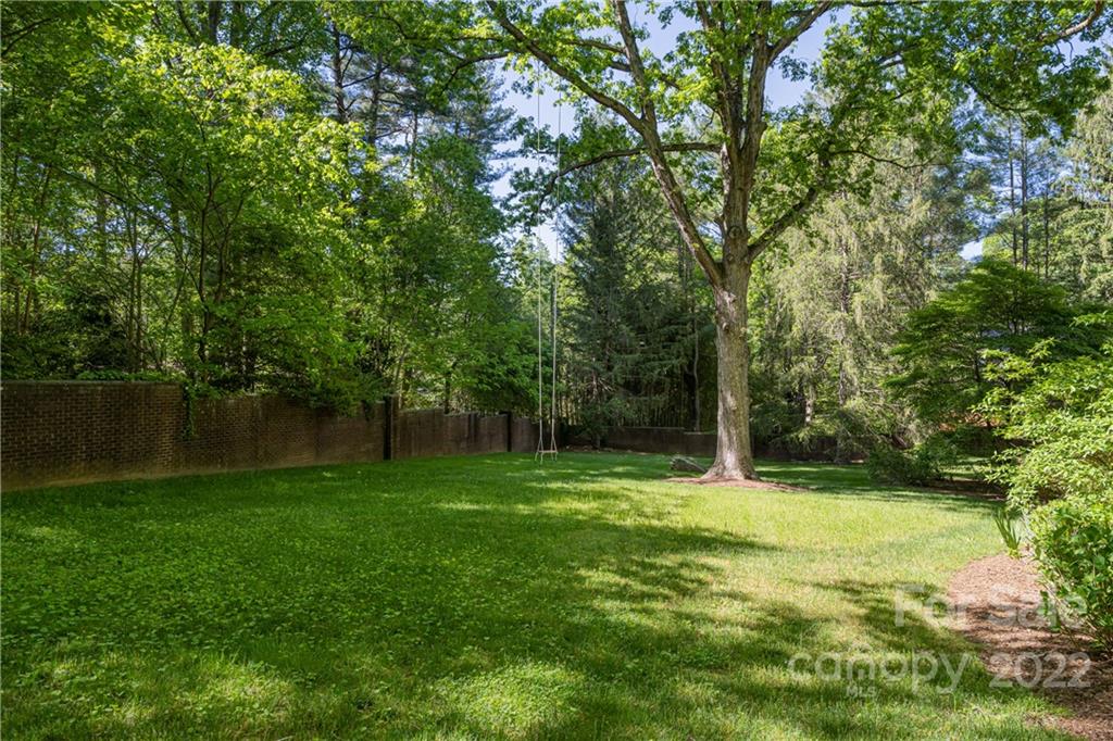 343 Vanderbilt Road Asheville, NC 28803 - Photo 46 of 48 a backyard of a house with lots of green space