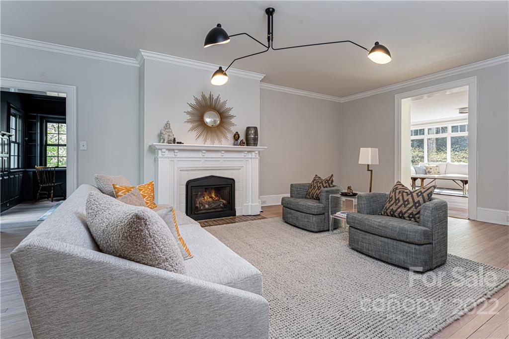 343 Vanderbilt Road Asheville, NC 28803 - Photo 5 of 48 a living room with furniture and a fireplace