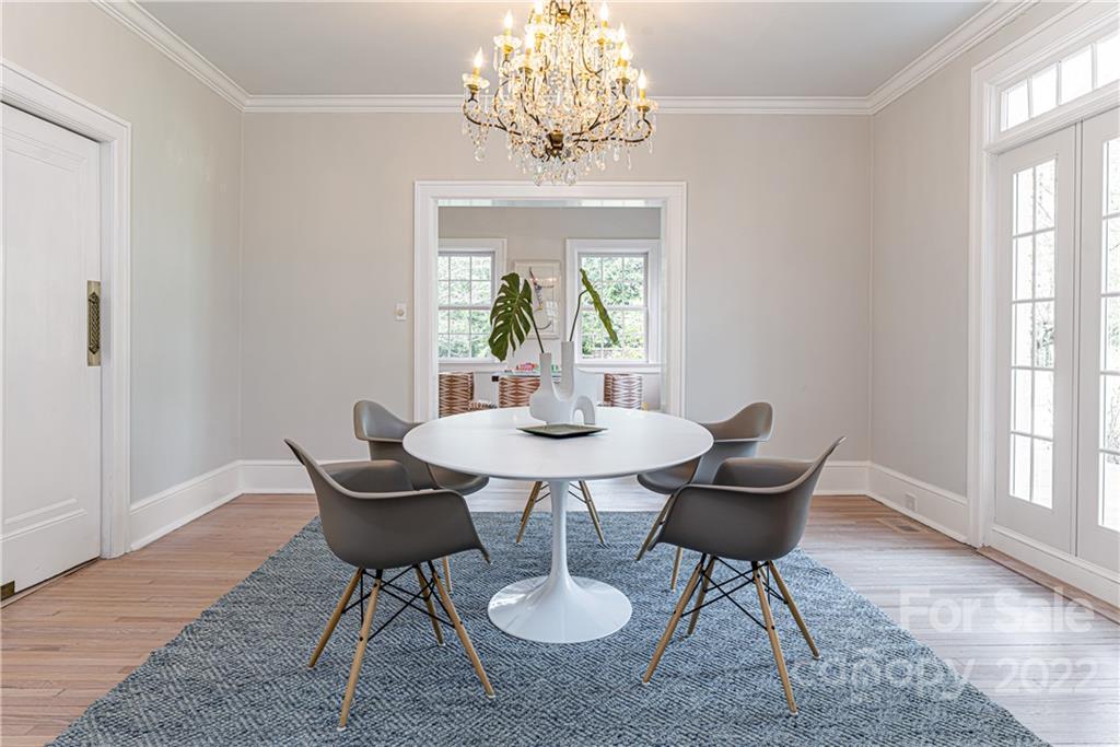 343 Vanderbilt Road Asheville, NC 28803 - Photo 9 of 48 a dining room with furniture a rug and a chandelier