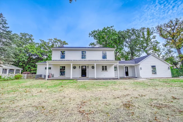 a house with trees in the background