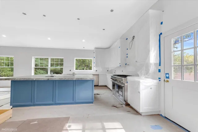 a kitchen with a stove a sink and a refrigerator