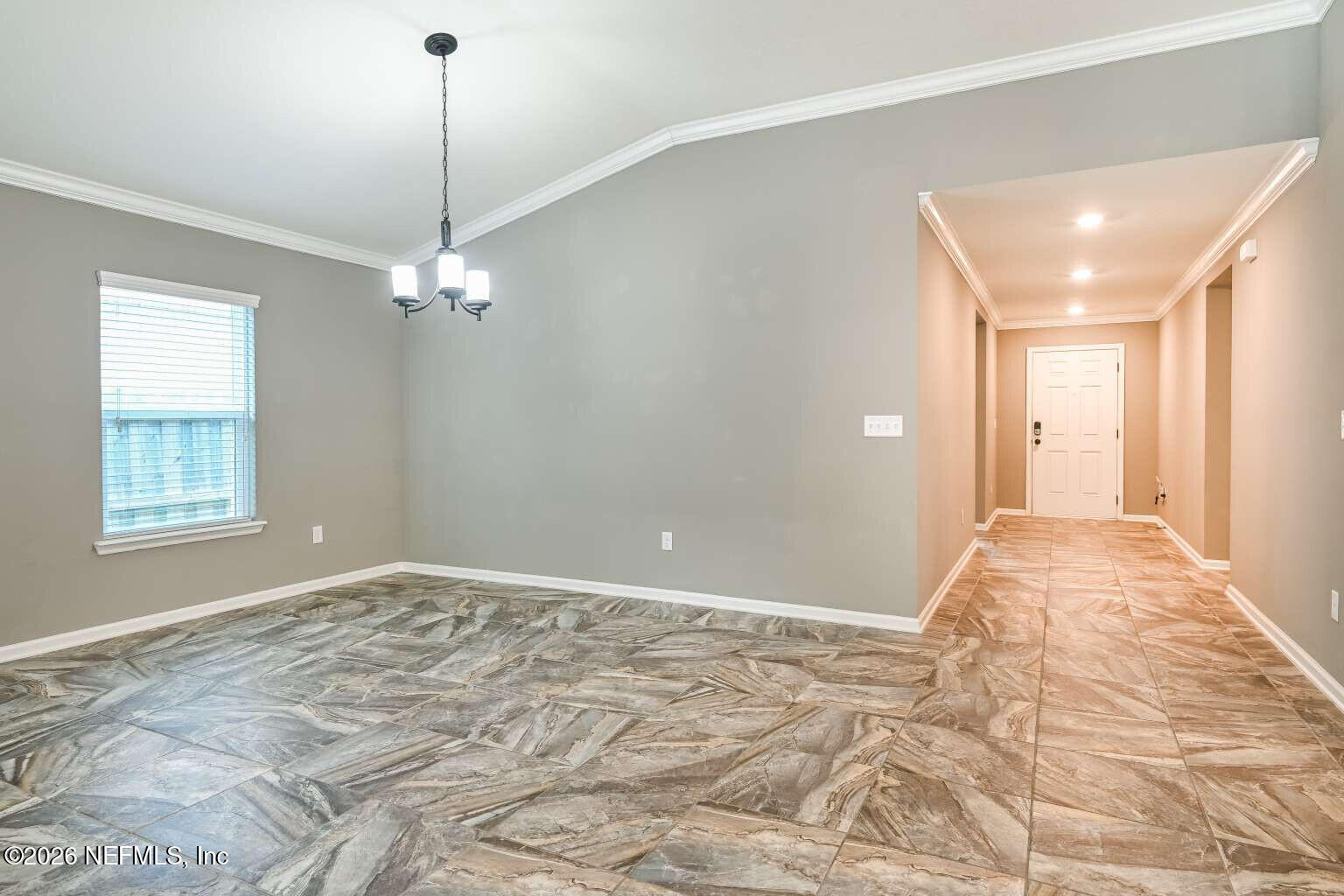 97572 Albatross Drive Yulee, FL 32097 - Photo 12 of 20 a view of an empty room with window and chandelier fan
