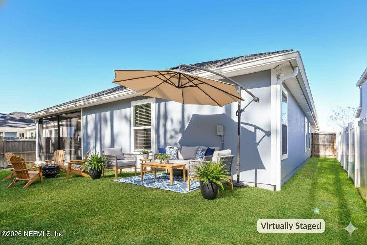 97572 Albatross Drive Yulee, FL 32097 - Photo 8 of 20 a view of a house with backyard sitting area and garden