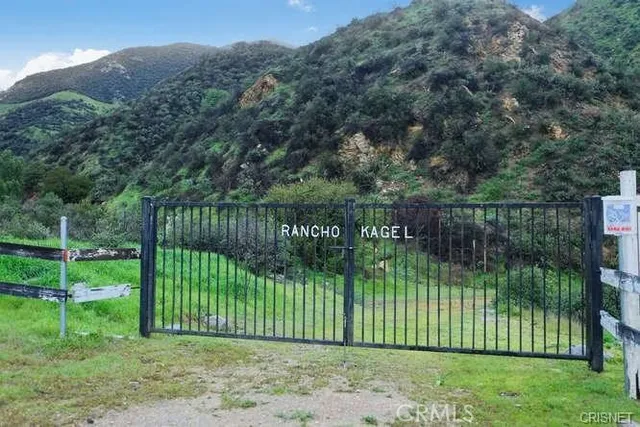 a view of a park with iron fence