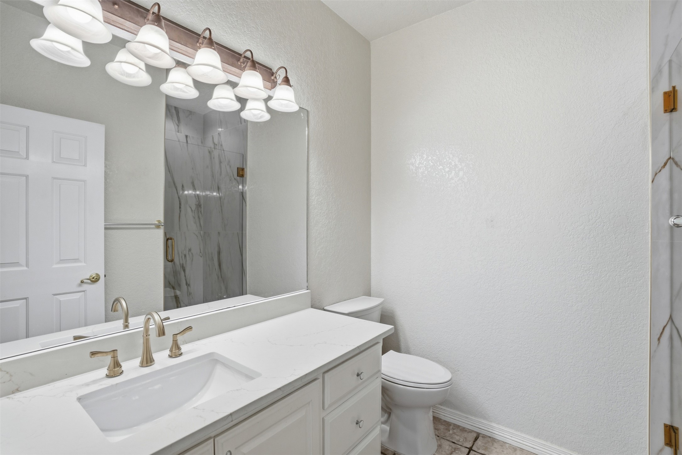 1301 County Road 262 Georgetown, TX 78633 - Photo 20 of 39 Bathroom featuring a white vanity with an integrated sink, brushed nickel faucet, large mirror, and a multi-bulb vanity light fixture