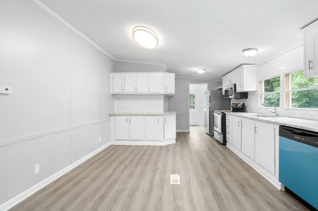a kitchen with wooden floors and appliances