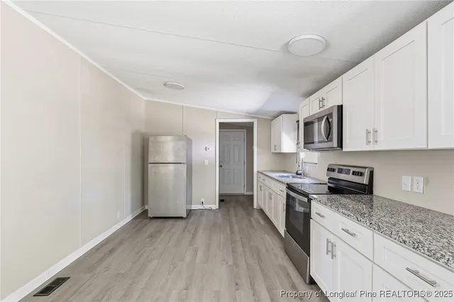 a kitchen with white cabinets and white appliances