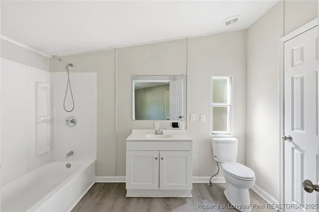a bathroom with a bathtub a sink a toilet and a mirror