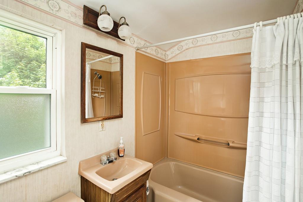 533 Highview Road Pittsburgh, PA 15234 - Photo 12 of 22 a bathroom with a sink a mirror and a shower