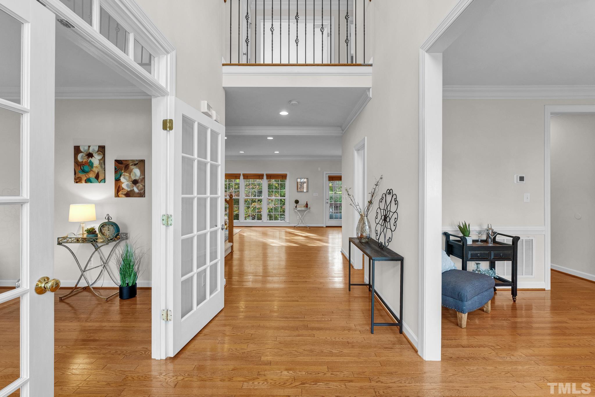 8409 Aptos Court Raleigh, NC 27613 - Photo 13 of 46 a hallway with wooden floor and furniture