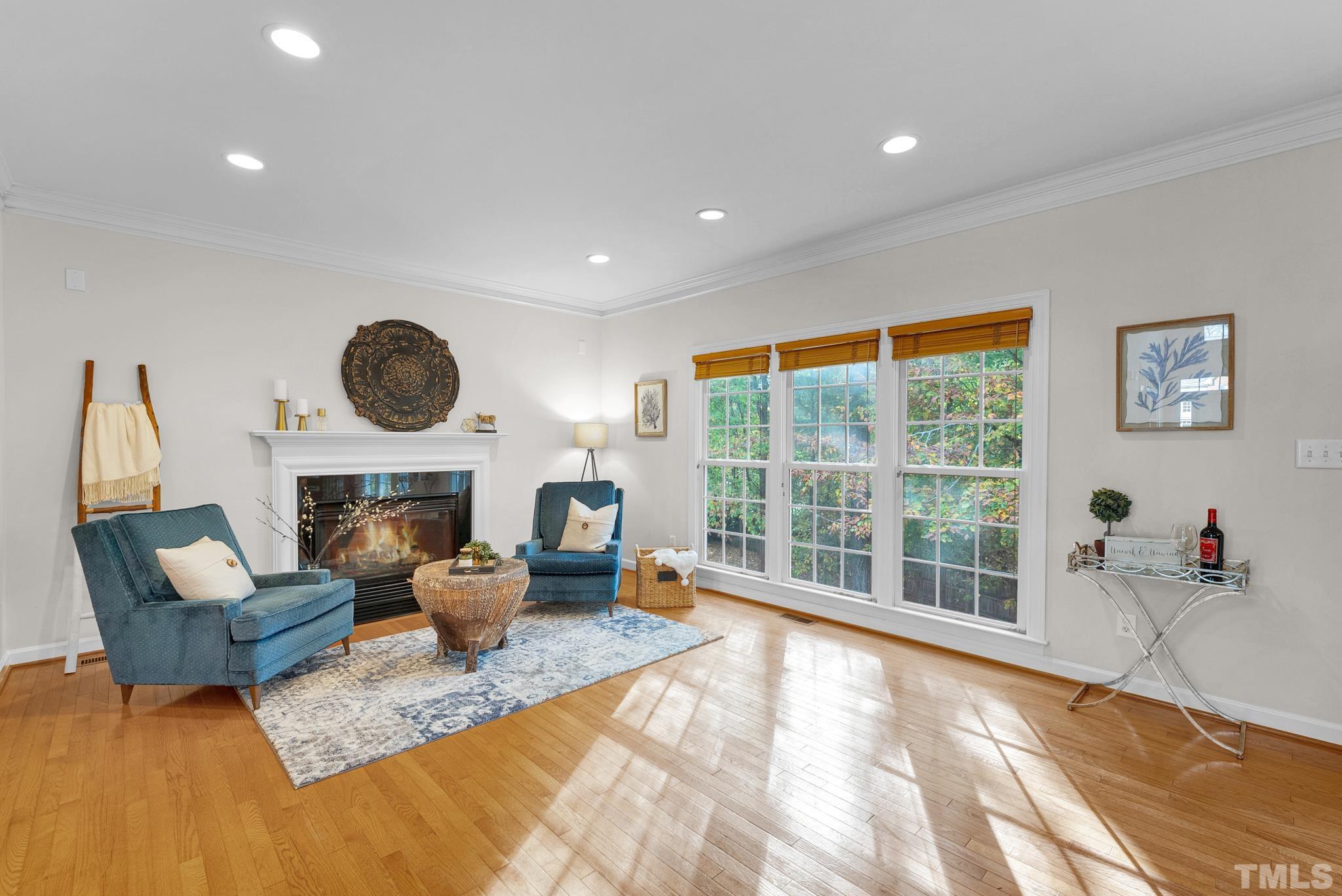 8409 Aptos Court Raleigh, NC 27613 - Photo 15 of 46 a living room with furniture a fireplace and a large window