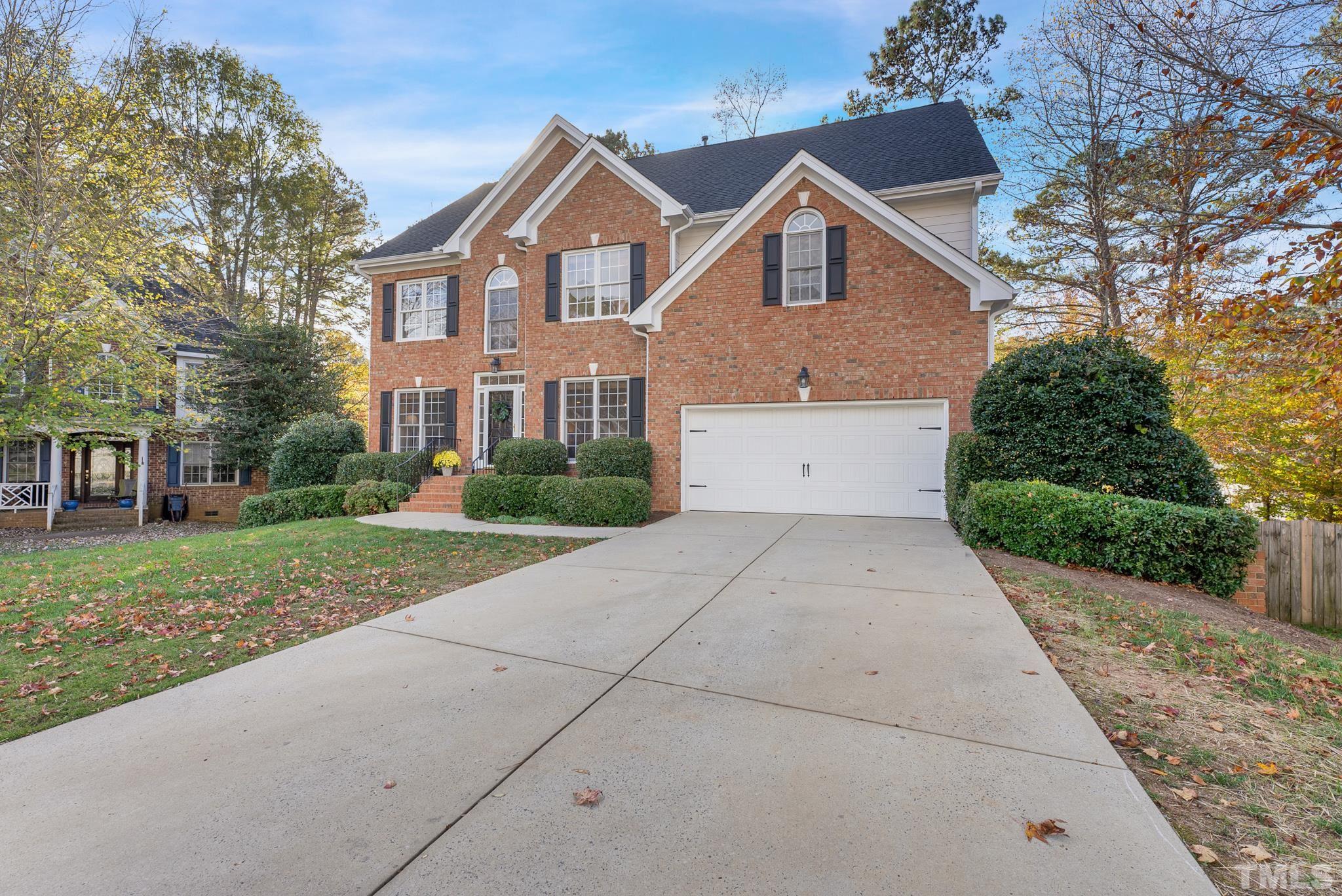 8409 Aptos Court Raleigh, NC 27613 - Photo 2 of 46 a view of a white house with a yard and potted plants