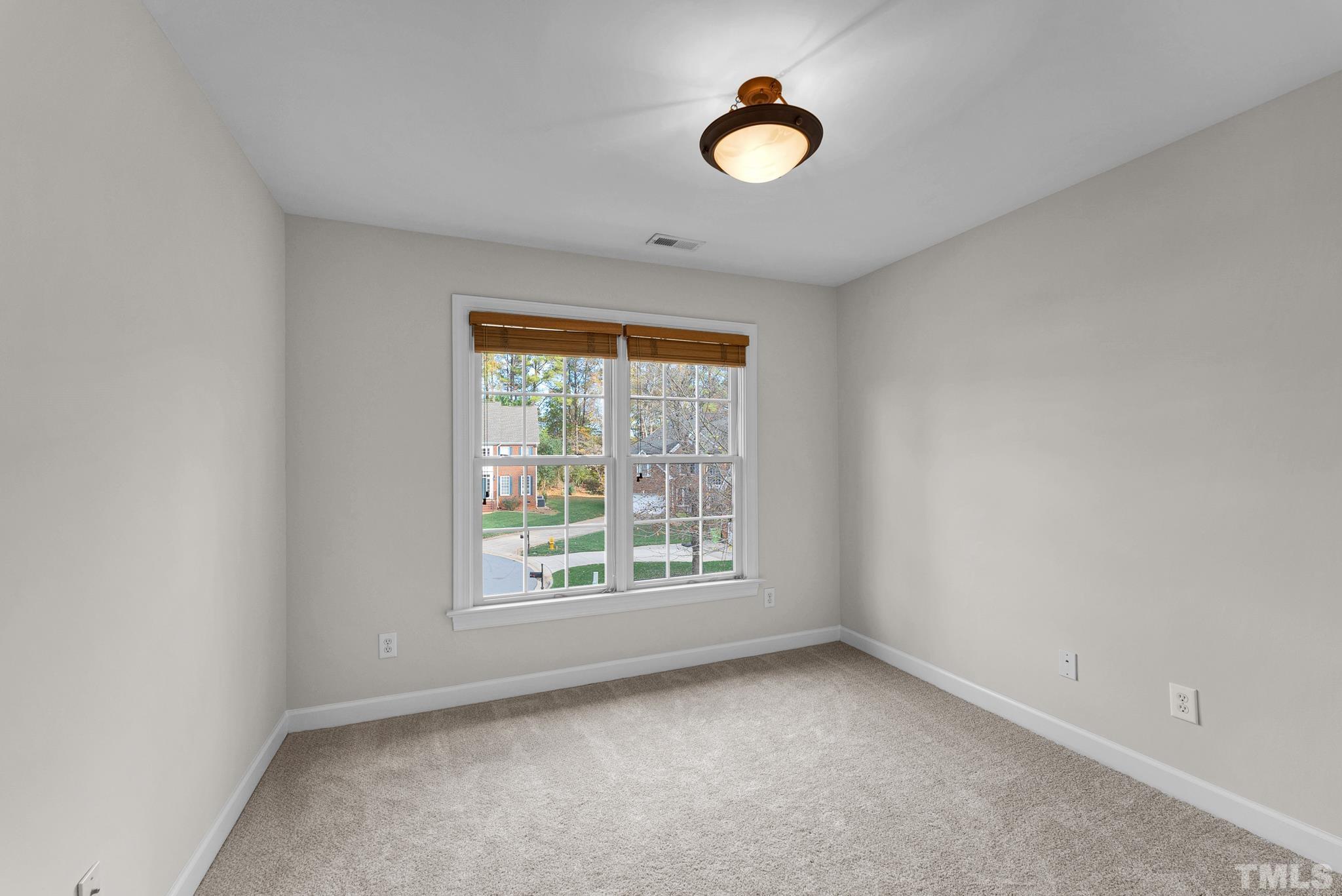 8409 Aptos Court Raleigh, NC 27613 - Photo 26 of 46 an empty room with windows