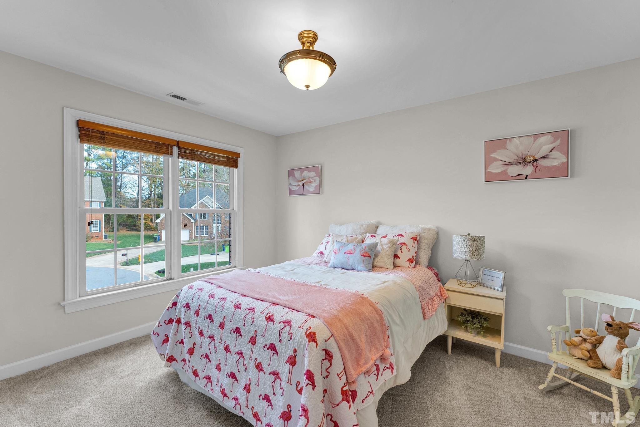 8409 Aptos Court Raleigh, NC 27613 - Photo 38 of 46 a bedroom with a bed and a window