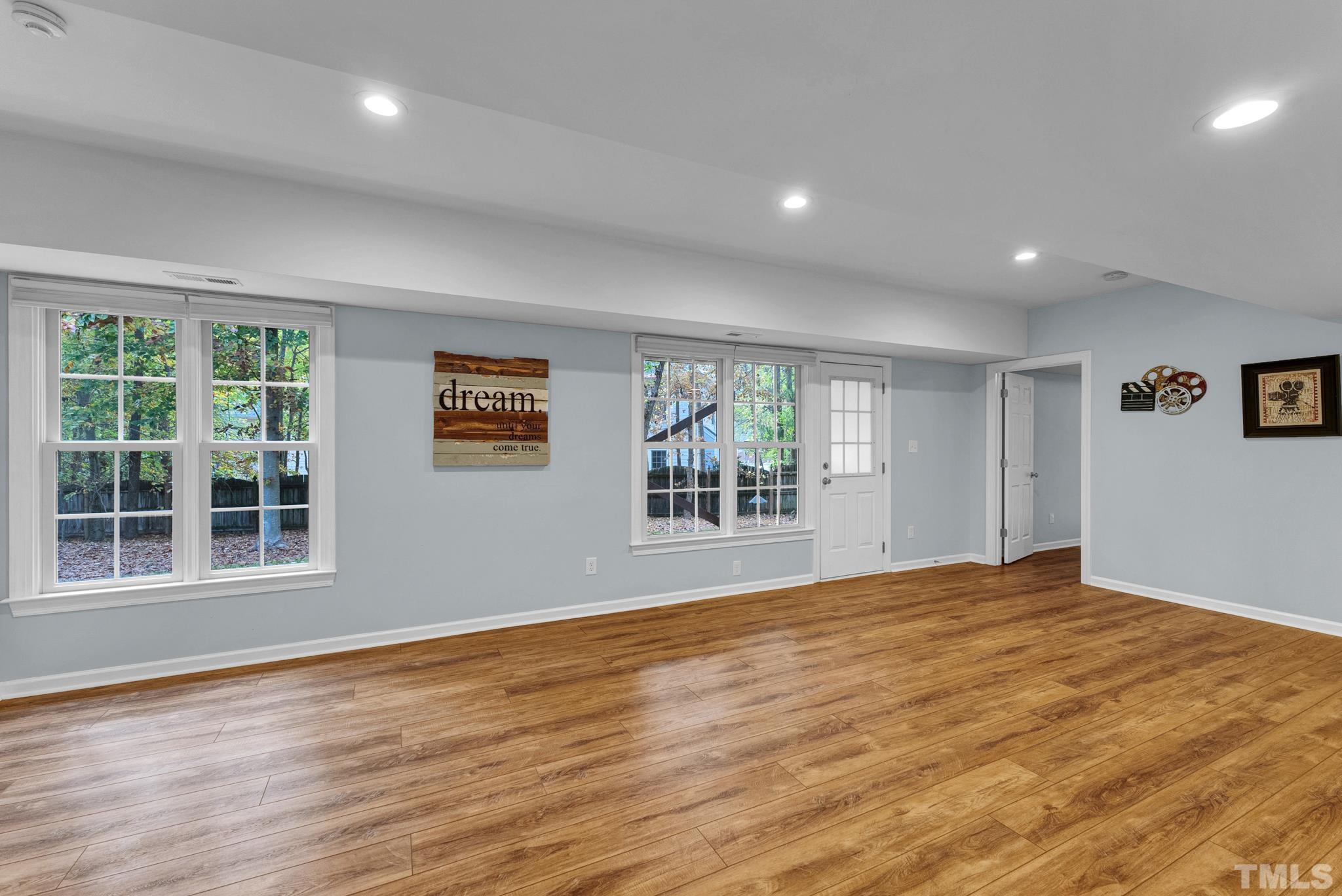 8409 Aptos Court Raleigh, NC 27613 - Photo 39 of 46 a view of an empty room with a window and wooden floor