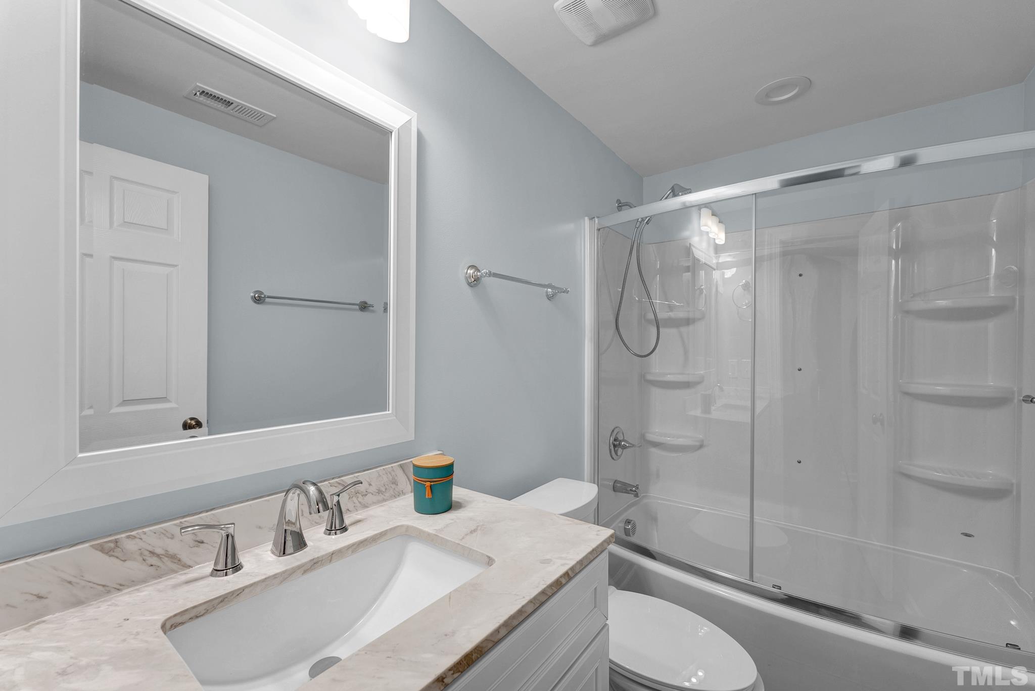 8409 Aptos Court Raleigh, NC 27613 - Photo 41 of 46 a bathroom with a sink toilet vanity and shower