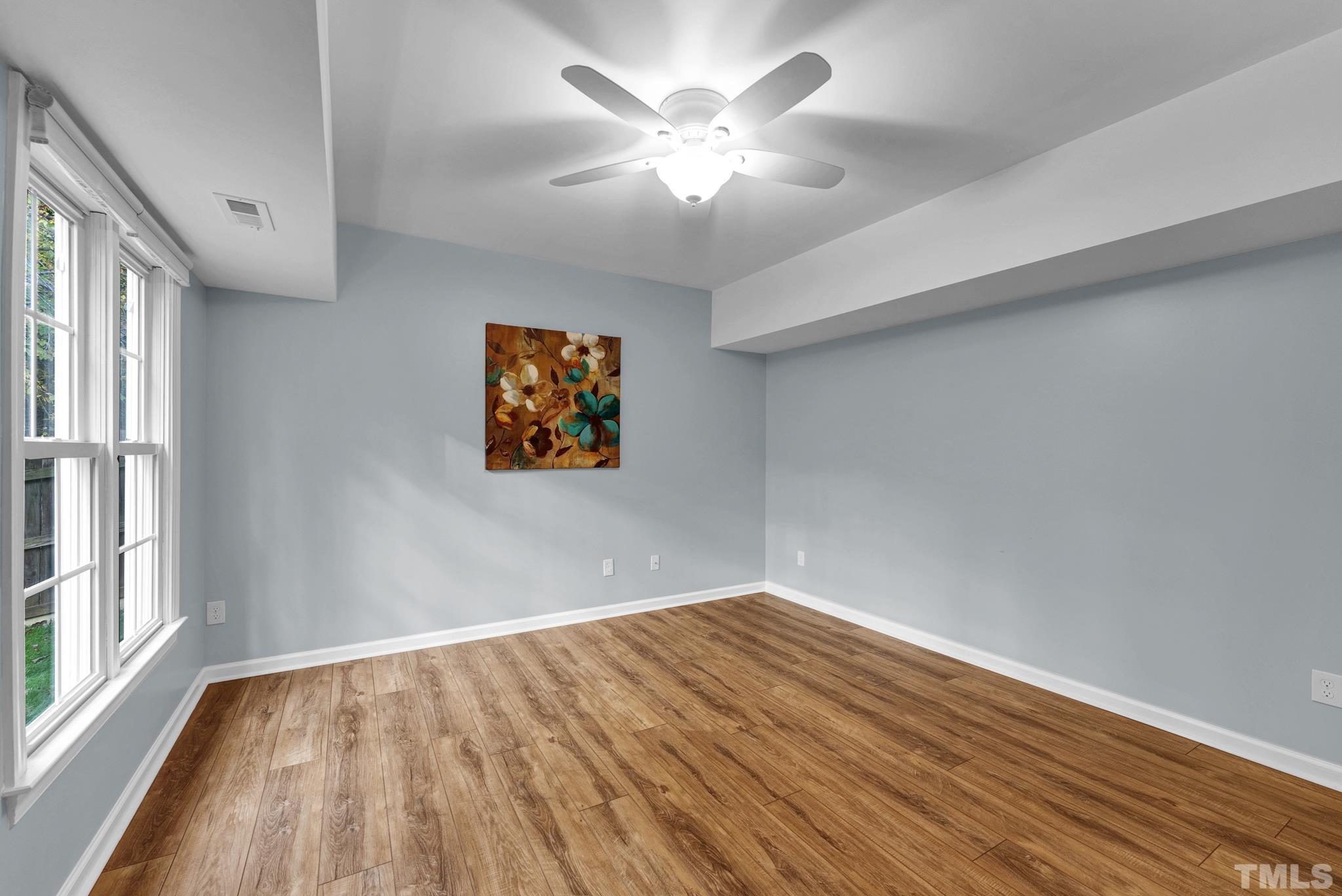8409 Aptos Court Raleigh, NC 27613 - Photo 42 of 46 wooden floor in an empty room with a window