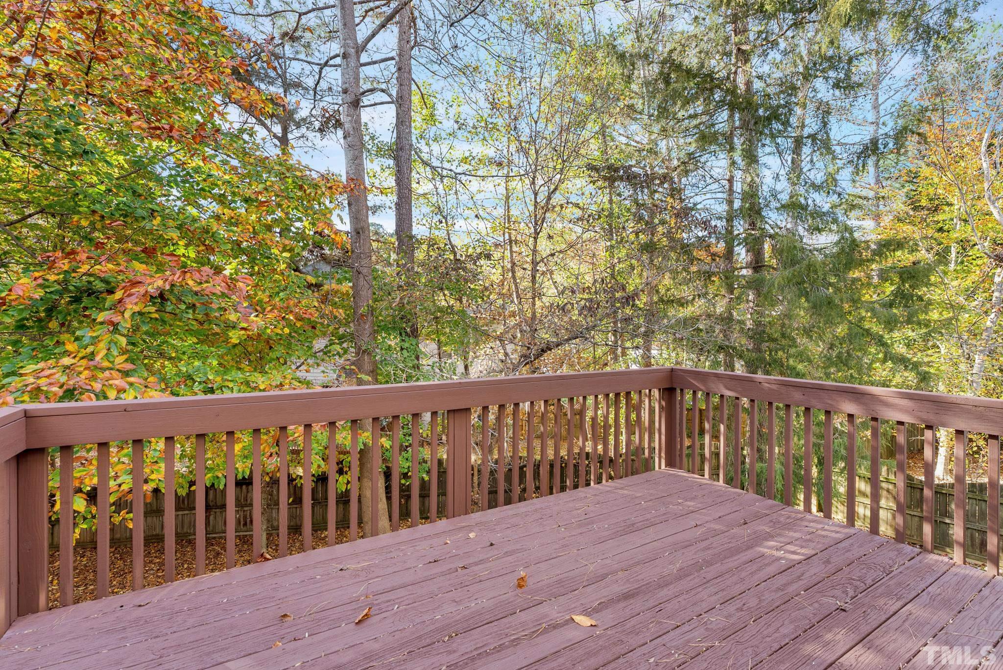 8409 Aptos Court Raleigh, NC 27613 - Photo 8 of 46 a balcony with wooden floor and fence