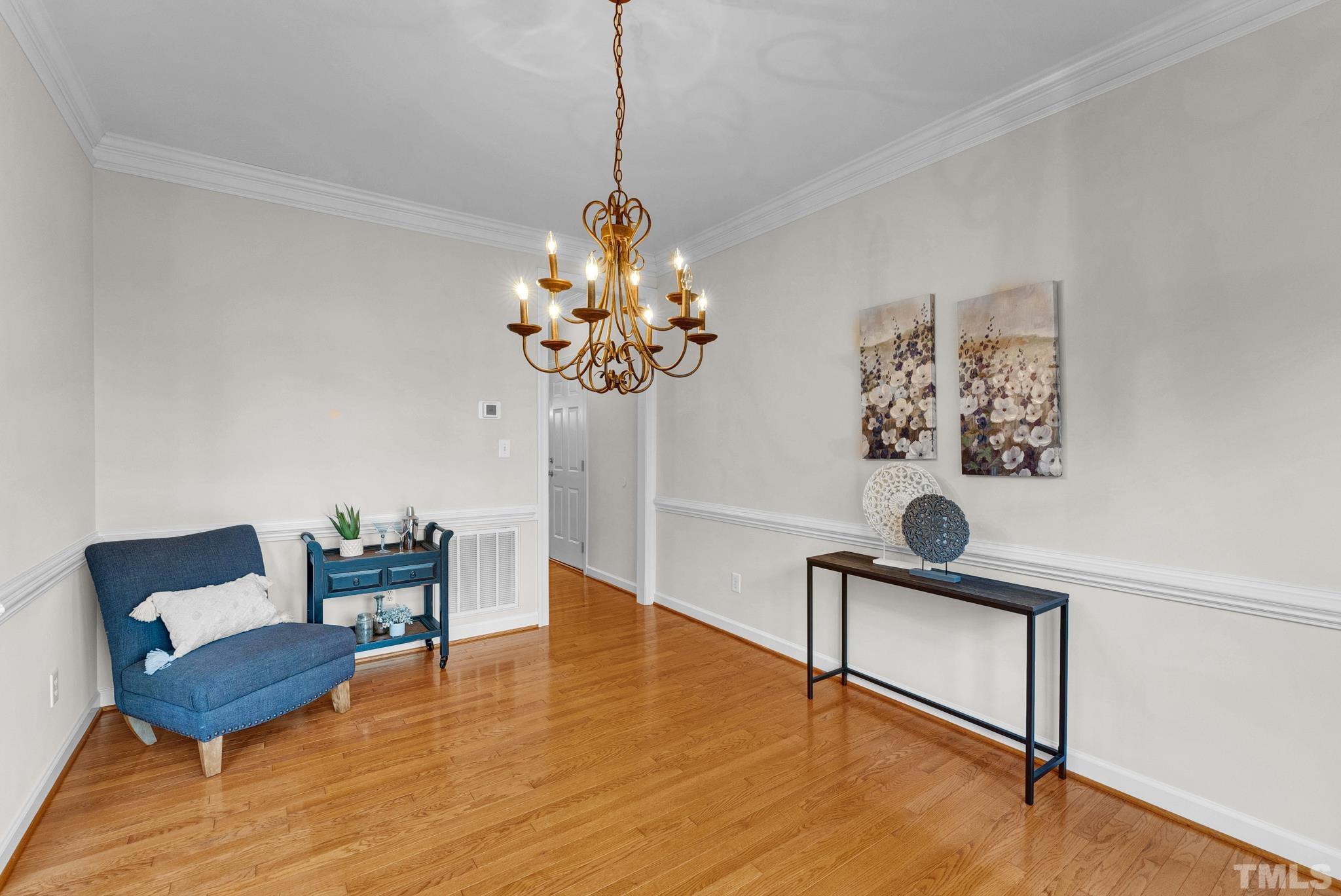 8409 Aptos Court Raleigh, NC 27613 - Photo 10 of 46 a view of a dining room with furniture wooden floor and a chandelier