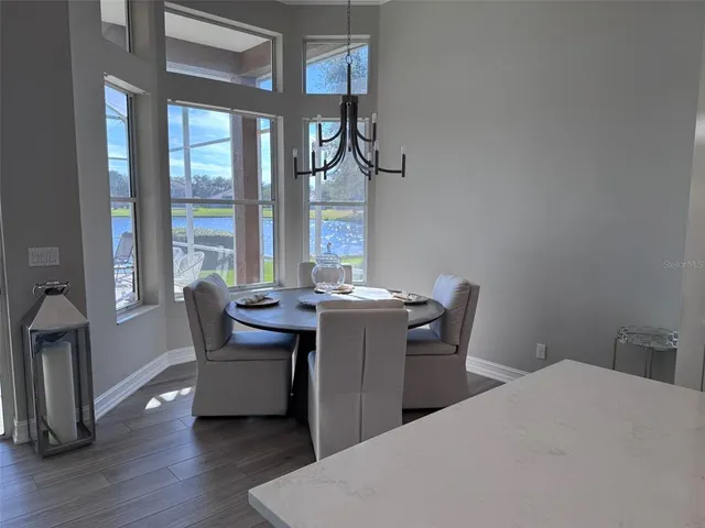 a dining room with furniture and wooden floor