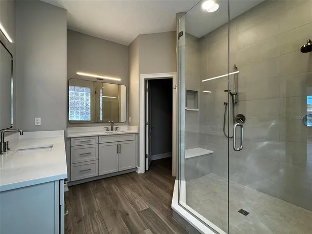 a view of an empty room with wooden floor