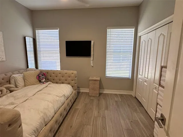 a bedroom with a bed and a flat screen tv