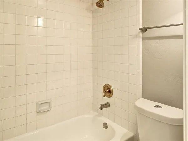 a bathroom with a bathtub and a toilet