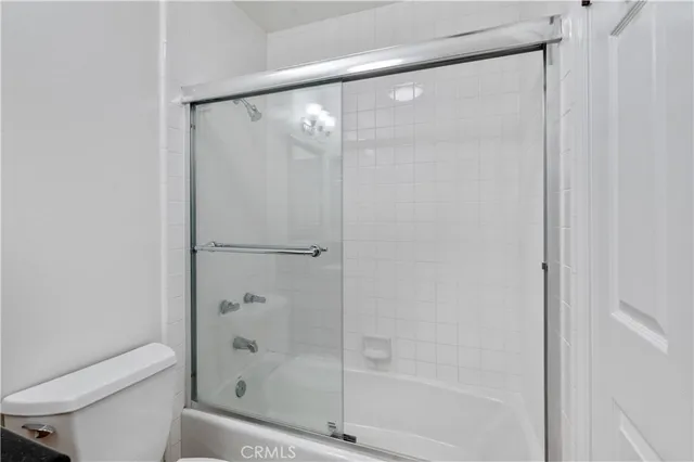 a bathroom with a glass shower door