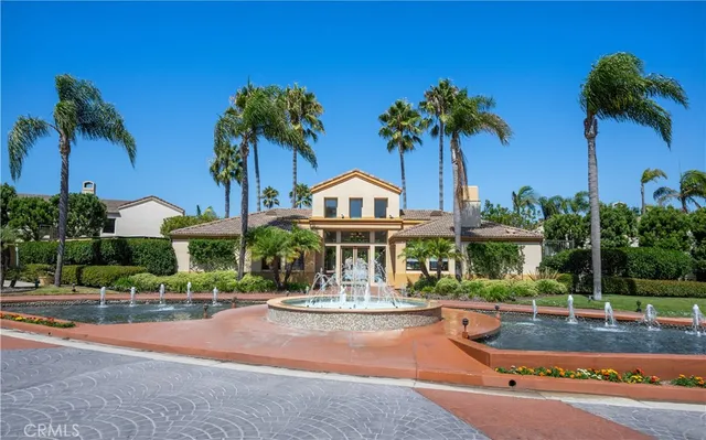 a front view of a house with palm trees