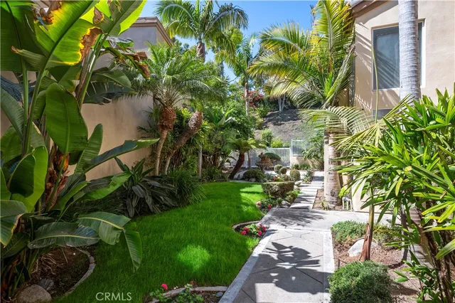 a backyard of a house with a garden and outdoor seating