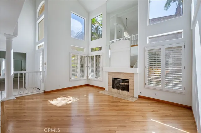 a view of an empty room with exposed radiator and fireplace