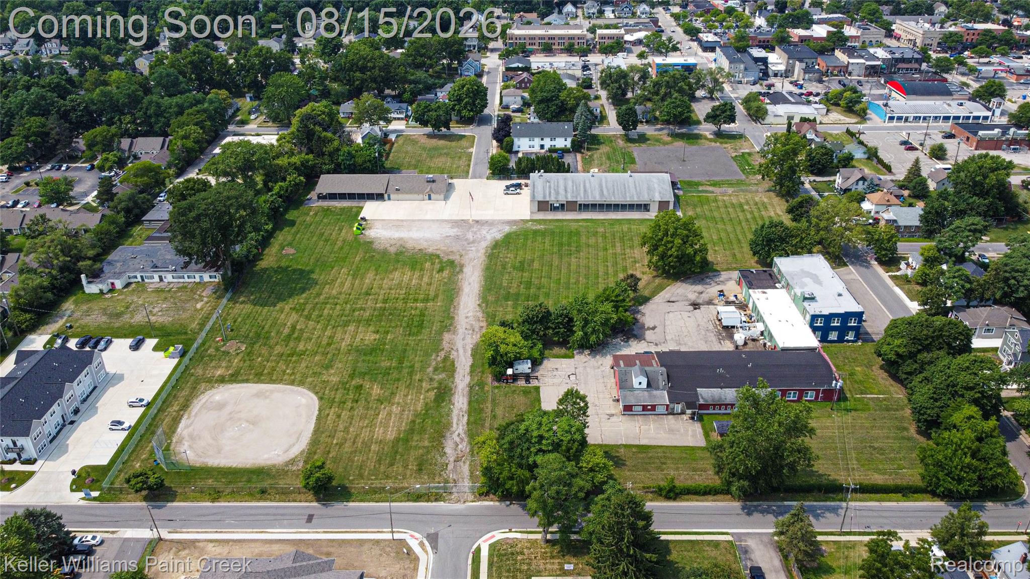 330 East Washington Street Romeo, MI 48065 - Photo 64 of 68 Expansive land parcel with surrounding commercial and residential properties, featuring a large open field area