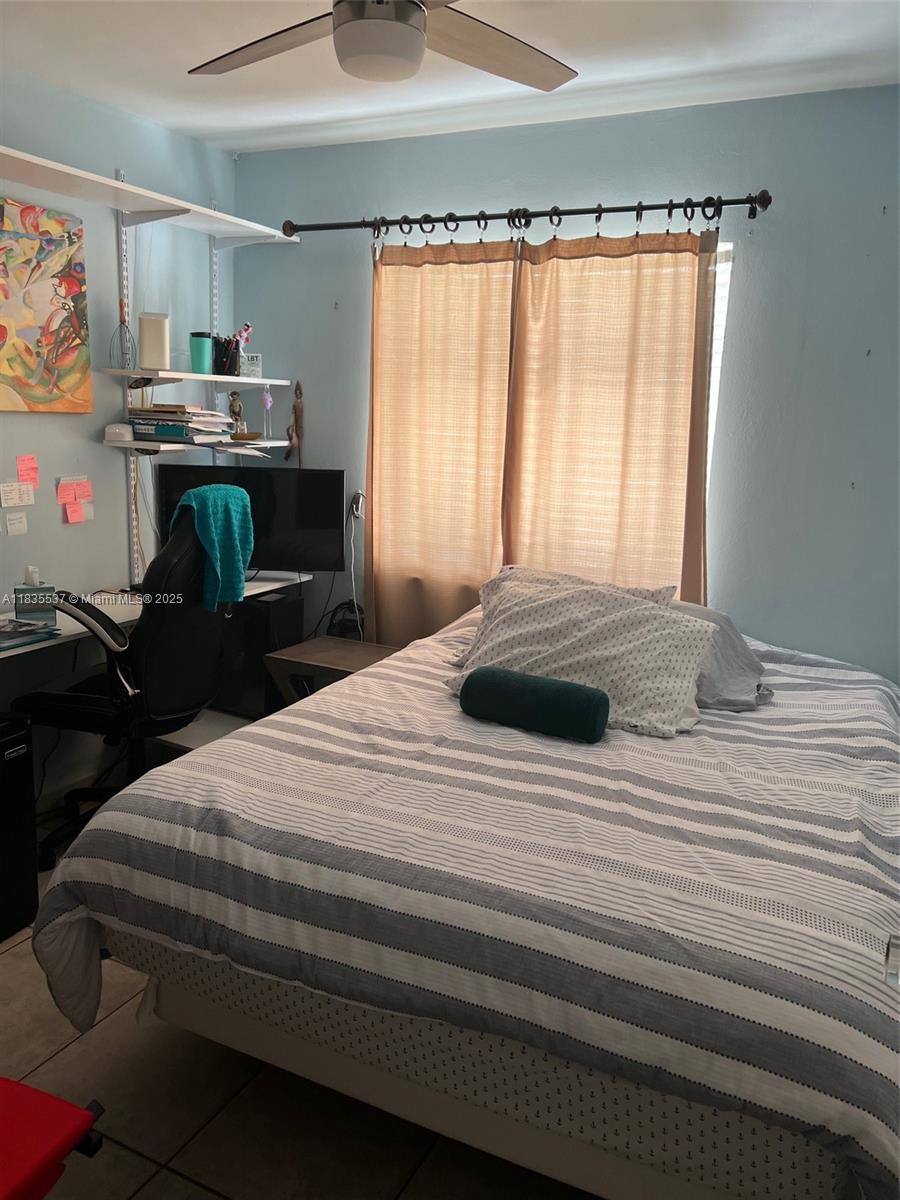 7595 Southwest 28th Street Miami, FL 33155 - Photo 2 of 8 a bedroom with a bed and a window