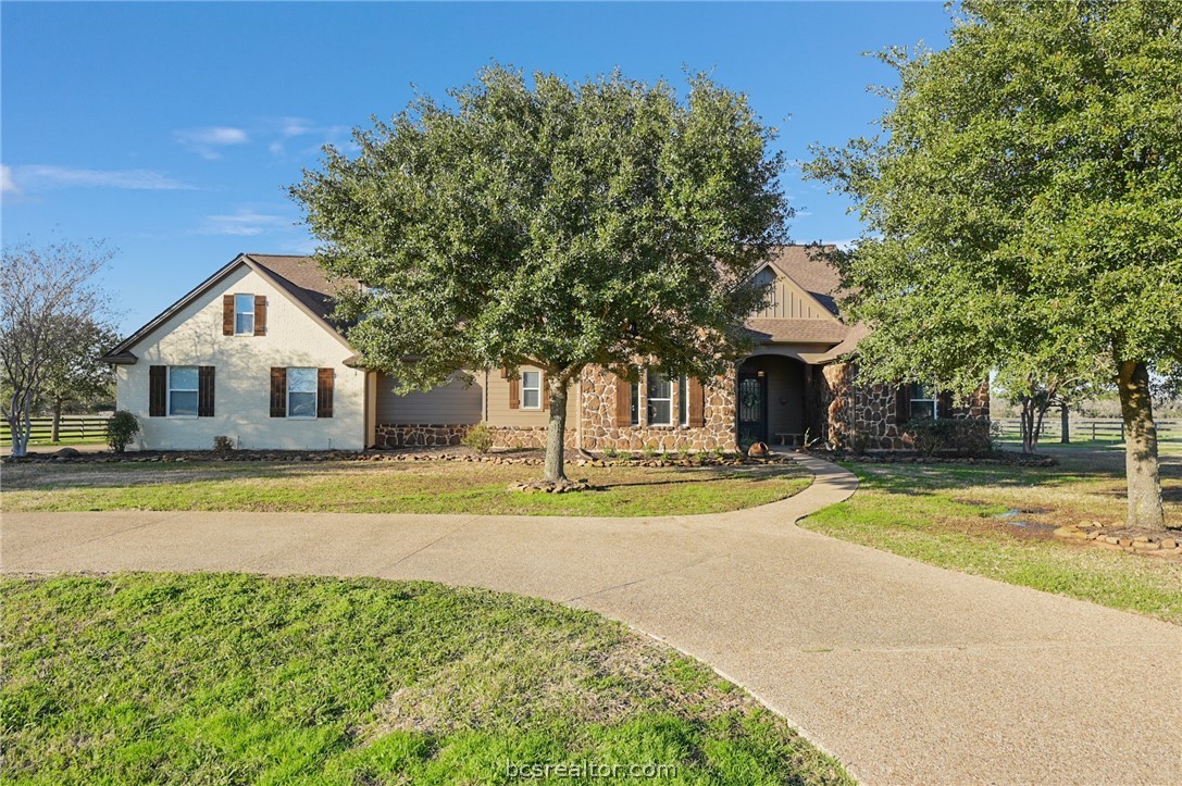 a view of a house with pool and a yard