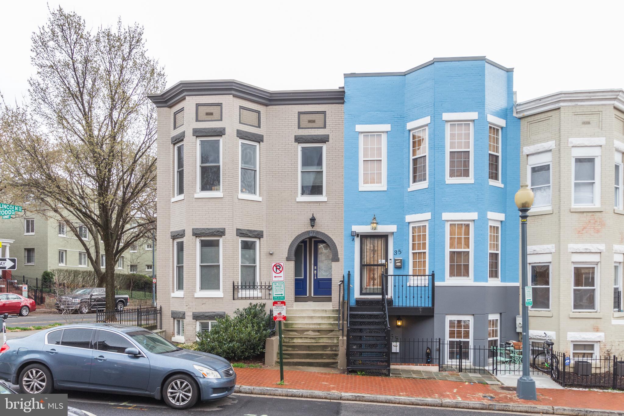 a front view of a building with parking space