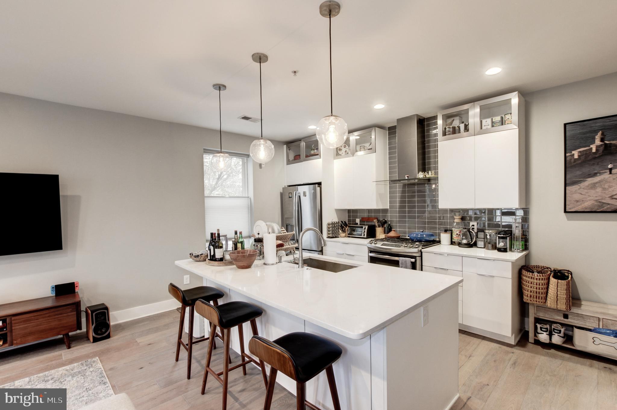 37 Todd Place Northeast, Unit 3 Washington, DC 20002 - Photo 11 of 28 a kitchen with a sink a stove and chairs