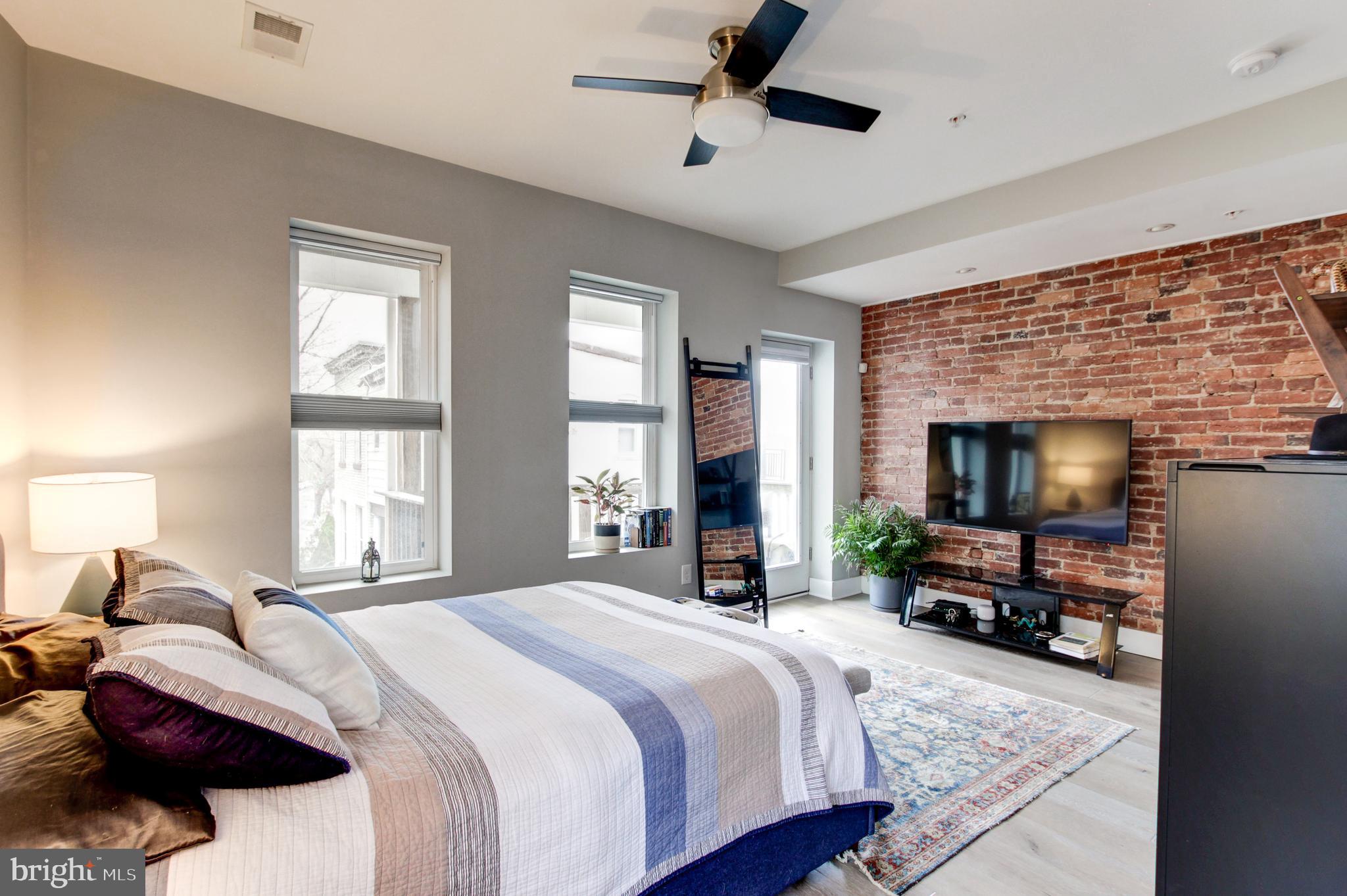 37 Todd Place Northeast, Unit 3 Washington, DC 20002 - Photo 16 of 28 a bedroom with a bed and a flat tv screen