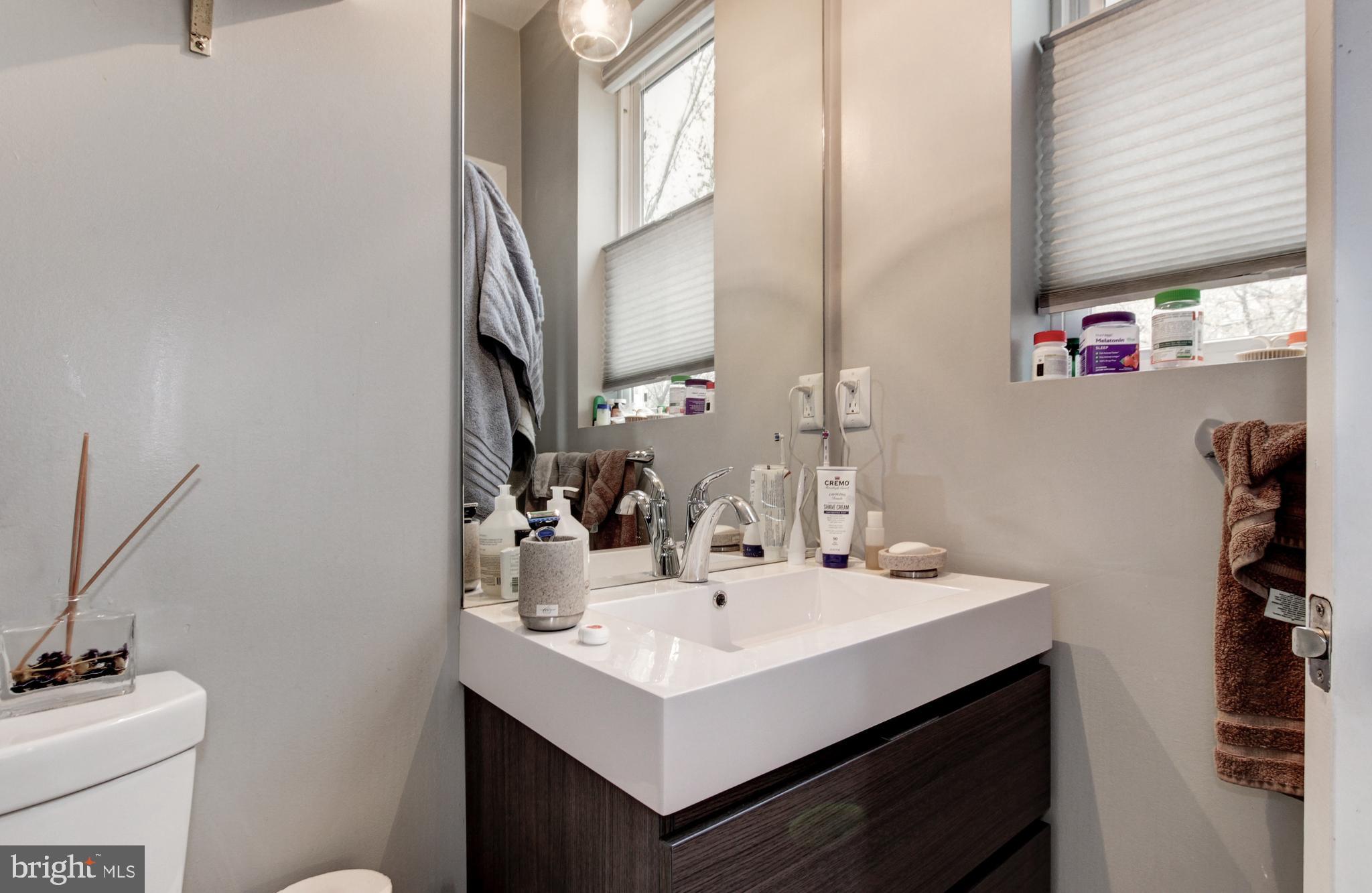 37 Todd Place Northeast, Unit 3 Washington, DC 20002 - Photo 18 of 28 a bathroom with a sink a mirror and vanity